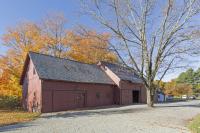 Color photo of the barns at the LWL, autumnal trees behind