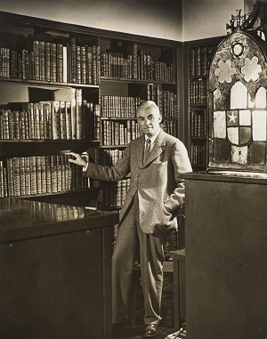 WIlmarth Lewis standing in his library