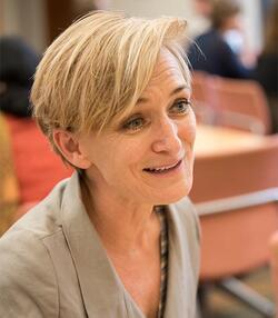 Color headshot of Annette Richards, a woman with short blond hair looking toward the right, a slight smile and raised eyebrows