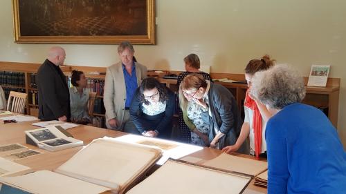 group of people looking at folio