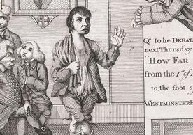 a short-statured figure with knees together, one hand raised in an oratorial gesture, the other holding a bag over his shoulder stands on a three-legged stool addressing an older man in a wig who leans down over a sign, a group of men sit on the left. 